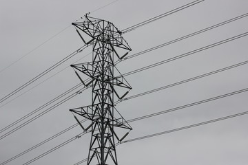 Transmission tower with a gray sky