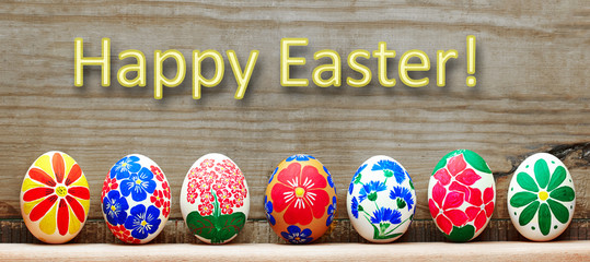 Easter eggs with a hand-drawn floral pattern on a wooden background