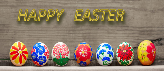 Easter eggs with a hand-drawn floral pattern on a wooden background