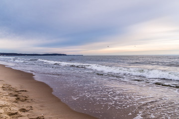 Waves on beach in sunset time. Baltic sea, Gdansk.