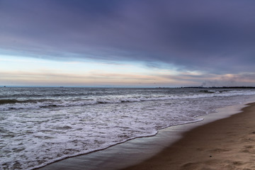 Waves on beach in sunset time. Baltic sea, Gdansk.