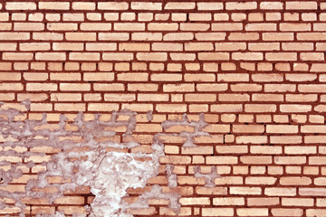 Old red toned weathered brick wall texture.