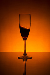 Still life with a glass and splashing wine	