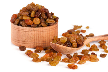 raisins in a wooden bowl with spoon isolated on white background