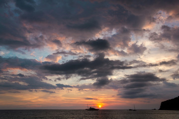 The cloudy sky and the ship. The ship floating under the heavy sky. Horizontal outdoors shot.
