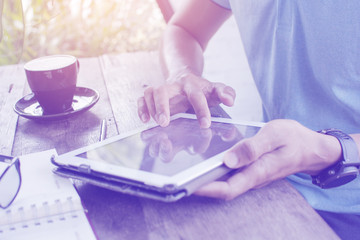 Thai Man typing a keypad of notepad for communication a job, fingers closeup on keypad