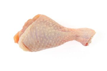 Raw chicken leg on a white background