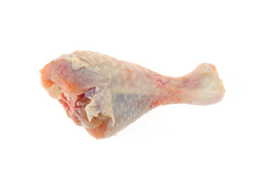 Raw chicken leg on a white background