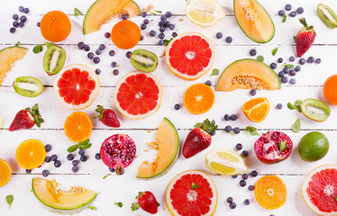 Fresh mixed fruits on white wooden background. Healthy  diet eating concept. Pattern.