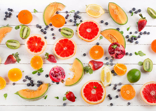 Mixed fruits on a white wooden background.