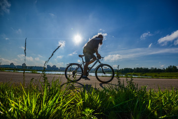 hipster man on a bicycle in the countryside