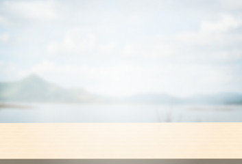 Polished birch table top on blurred mountains landscape background can put or montage your products