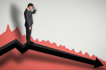 Businessman standing on a graph and looking down on the results