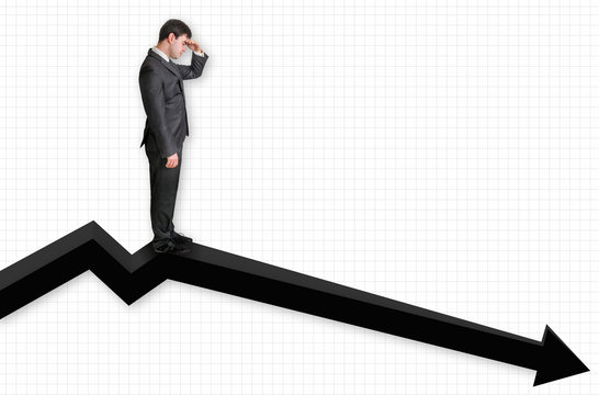 Businessman standing on a graph and looking down on the results