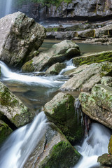 Stream Flowing Through Rocks in forest.