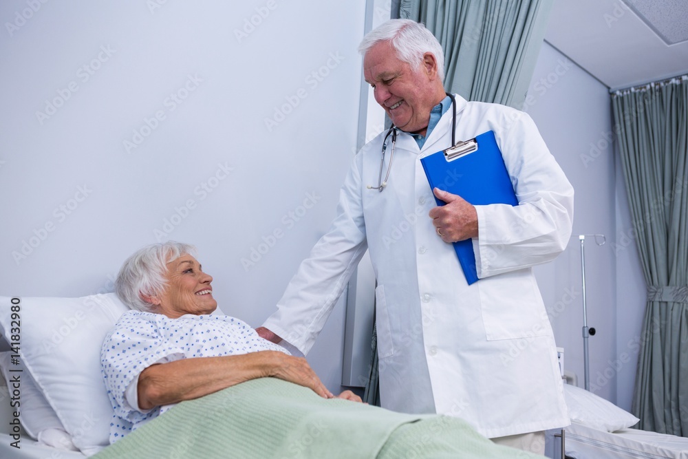 Wall mural Doctor consoling senior patient