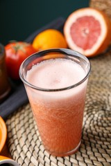 grapefruit juice in clear glass on wooden table 