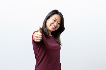 Enthusiastic motivated woman giving a thumb up