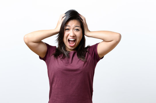 Excited woman screaming and holding head