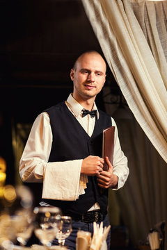 Waiter in uniform waiting an order,waiter order menu,Waiter with a white towel on his hand