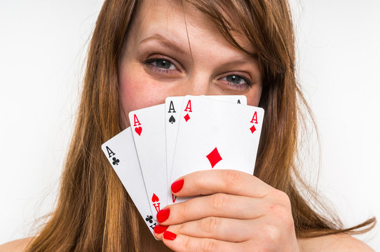 Attractive woman with poker cards isolated on white