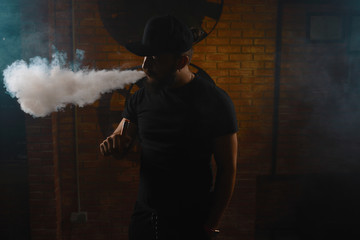 Fototapeta premium Man vaping an electronic cigarette