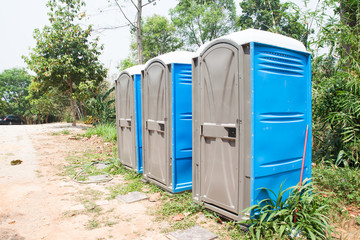 Blue Port Potties or Portable Toilets in nature public park