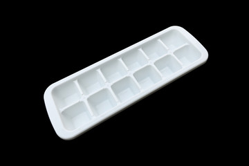 white plastic ice making tray isolated on black