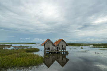 old wooden house on the water lake, Thailand