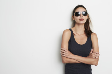 Cool attitude girl in vest and shades, portrait