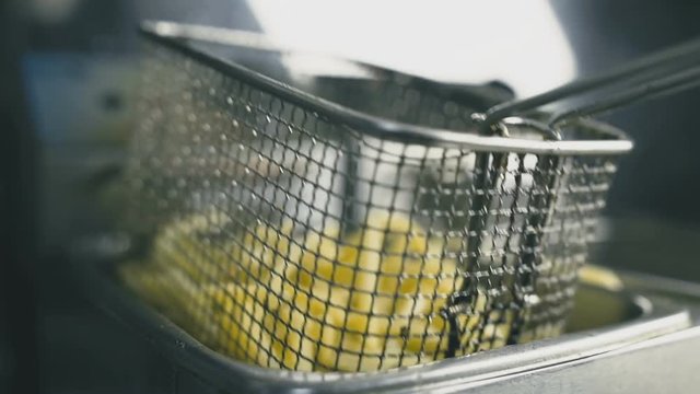 French fries in the deep fryer close-up