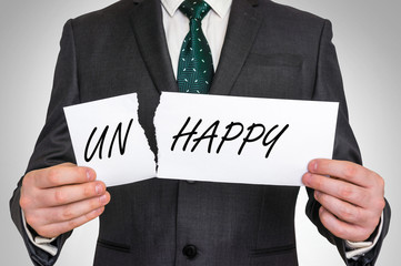 Businessman tearing paper with unhappy word