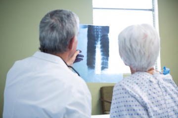 Doctor discussing x-ray report with senior patient