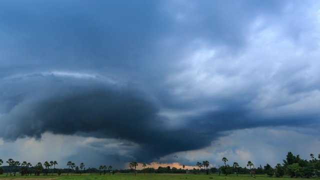 Time Lapse Nimbus Couds Floating And Raining Over Rural Field (zoom out)