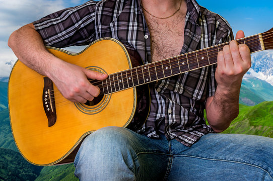 Young man playing acoustic guitar