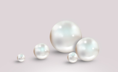 Five white pearls on grey pink background