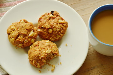 cereal cookie and coffee cup on wooden table