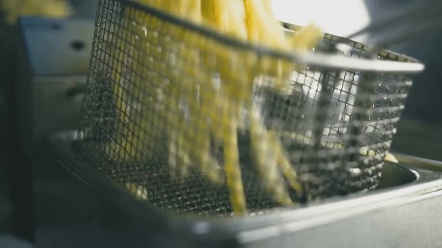 French fries in the deep fryer close-up