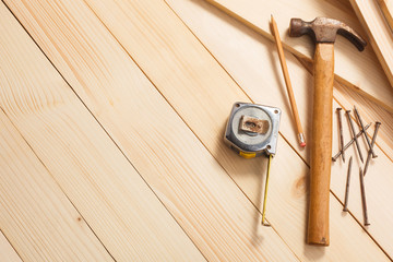 carpentry tools on wooden background, top view. Empty space for Your text in the left side.