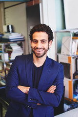 The portrait of Arab businessman jacket on the background of shelves with documents in the office