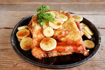 Banana French Toast on wooden table.