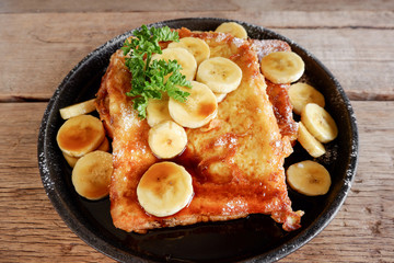 Banana French Toast on wooden table.