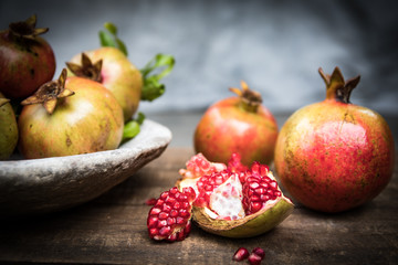 Pomegranate fruit arranged on wooden table top