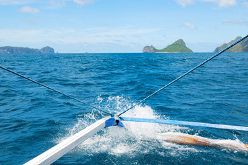 view of the island hill from the prow of a boat