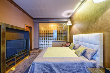Russia, Moscow - modern designer renovation in a luxury building. Stylish bedroom interior with double bed.