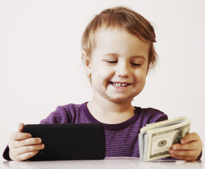 Very happy business baby girl with smart phone and dollar banknotes celebrating good news. Success, wealth management concept. (Humorous picture)