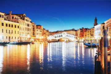 Fototapeta na wymiar City landscape. Rialto Bridge Ponte Di Rialto in Venice, Italy at night. Many tourists visiting the beauty of the city throughout the year