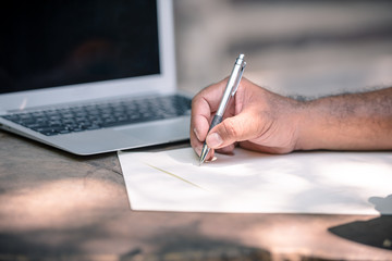 Successful business man writing a business plan to grow business up more