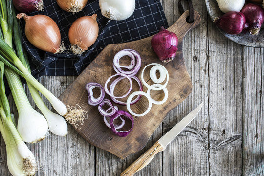 Raw onions on wooden table