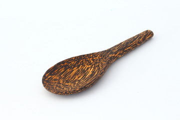 Wooden spoon with beautiful pattern on a white background.